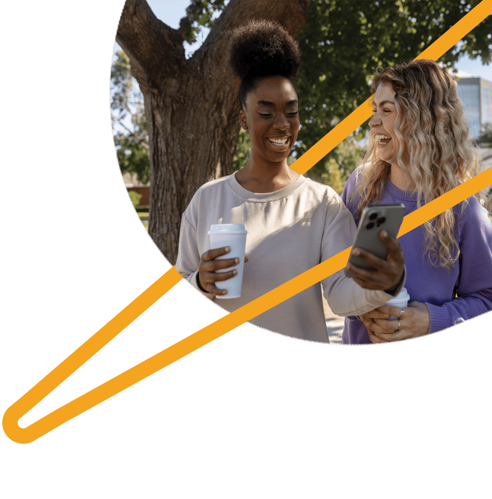 Two friends taking selfies outdoors.